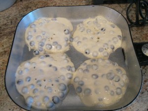 Blueberries pancakes in pan